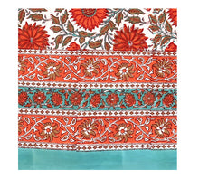 Load image into Gallery viewer, A block print tablecloth with floral patterns in red, green, and white colors spread out on a surface.