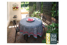 Load image into Gallery viewer, Round table with a patterned tablecloth in an outdoor setting with &#39;Casa Boho&#39; branding.

